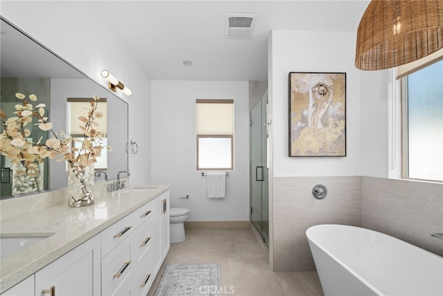 full bath featuring visible vents, a soaking tub, a stall shower, a sink, and toilet