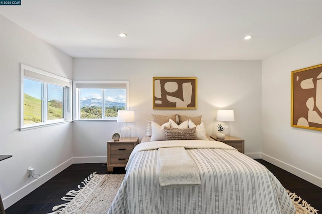 bedroom with dark wood-type flooring