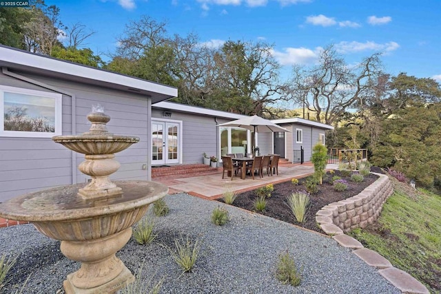 rear view of property with a patio and french doors