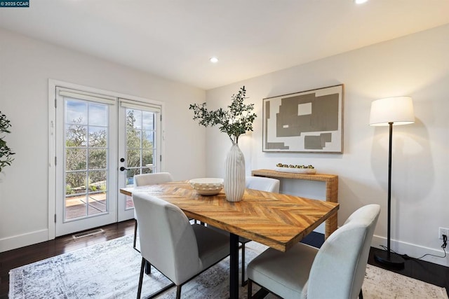 dining space with dark hardwood / wood-style floors and french doors