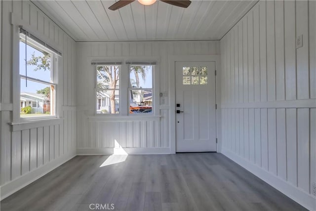 unfurnished sunroom featuring wood ceiling and ceiling fan