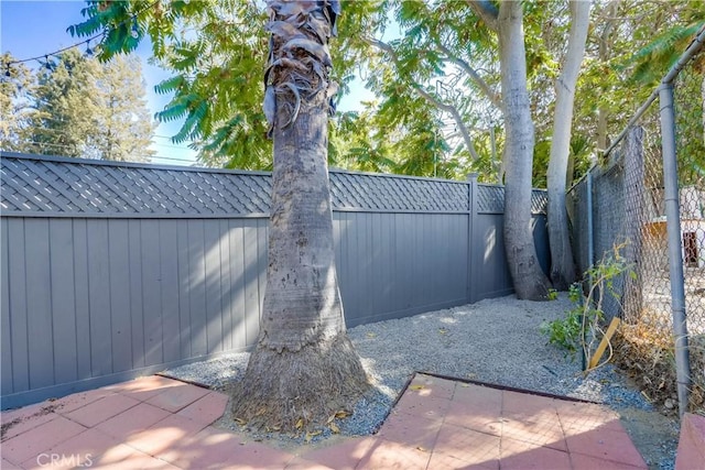 view of gate featuring a patio