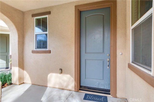 property entrance with stucco siding