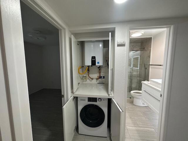 washroom featuring washer / clothes dryer and tankless water heater