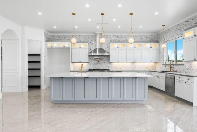 kitchen with crown molding, hanging light fixtures, dishwasher, an island with sink, and wall chimney range hood