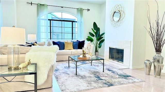 living room with light wood-type flooring and a fireplace