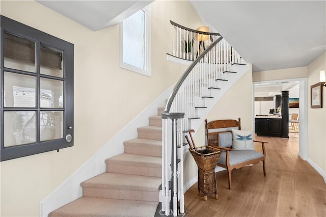 stairs with hardwood / wood-style flooring