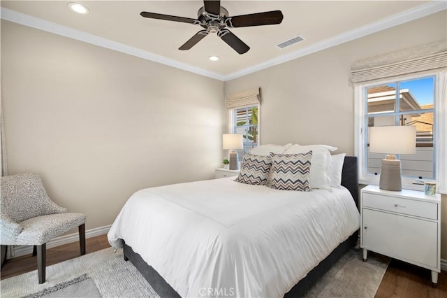 bedroom with multiple windows, ornamental molding, dark hardwood / wood-style floors, and ceiling fan