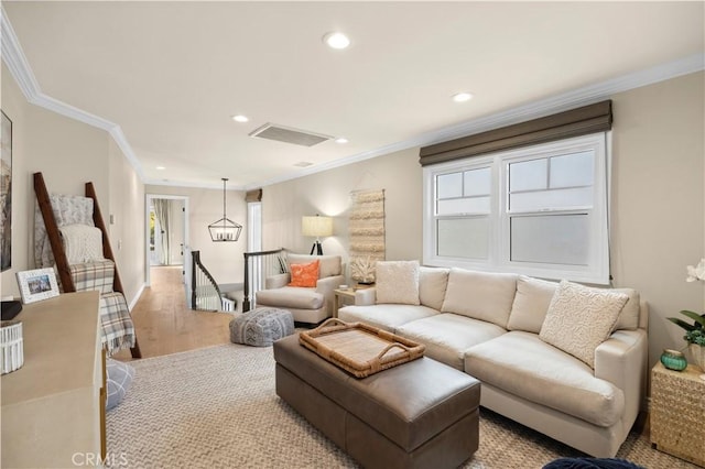 living room featuring ornamental molding and light wood-type flooring