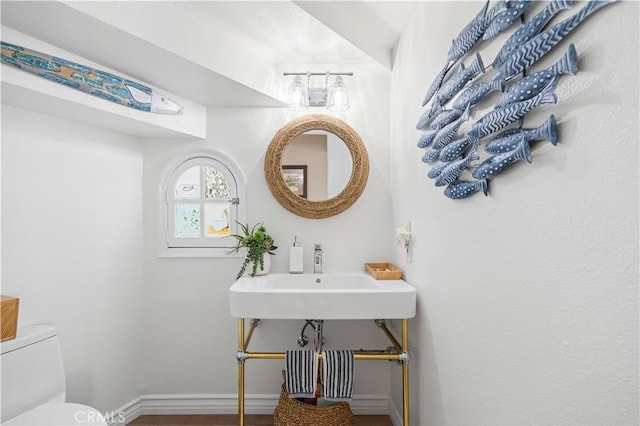 bathroom featuring sink and toilet