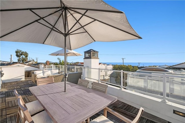 view of patio featuring a balcony and a water view