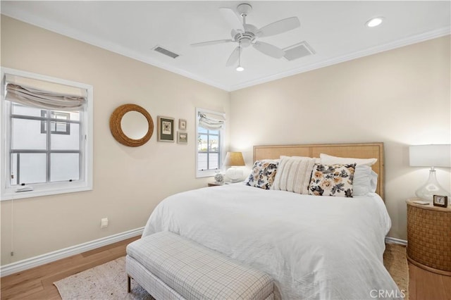 bedroom with ornamental molding, light hardwood / wood-style floors, and ceiling fan