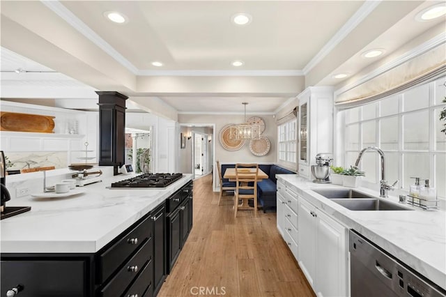 kitchen with dishwashing machine, sink, white cabinetry, ornamental molding, and stainless steel gas cooktop