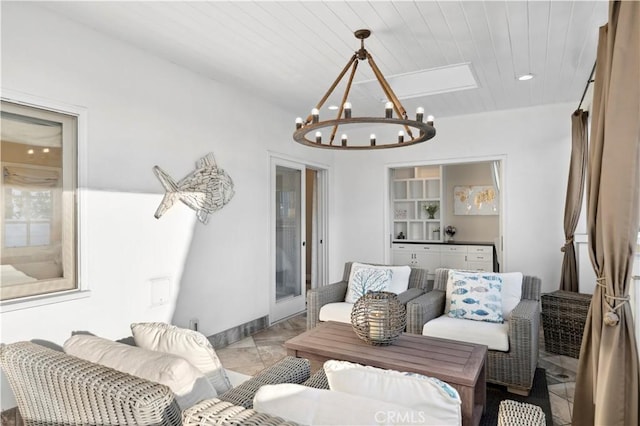 living room with a chandelier, built in features, and wooden ceiling