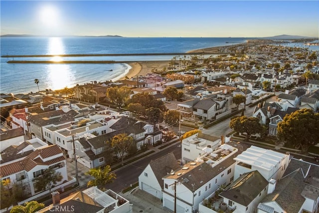 bird's eye view with a water view and a beach view