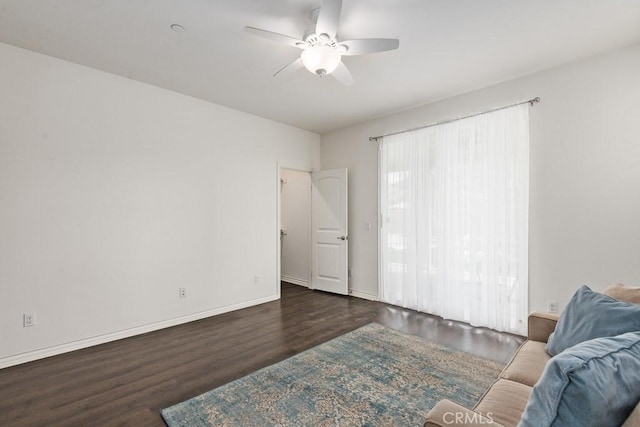 living room with dark hardwood / wood-style floors and ceiling fan