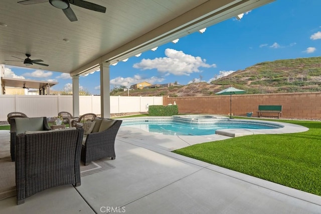 view of pool with a patio, a yard, and ceiling fan