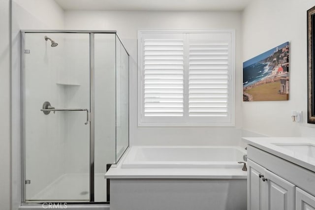 bathroom featuring vanity and separate shower and tub