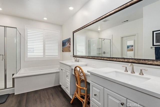 bathroom with vanity, shower with separate bathtub, and hardwood / wood-style floors