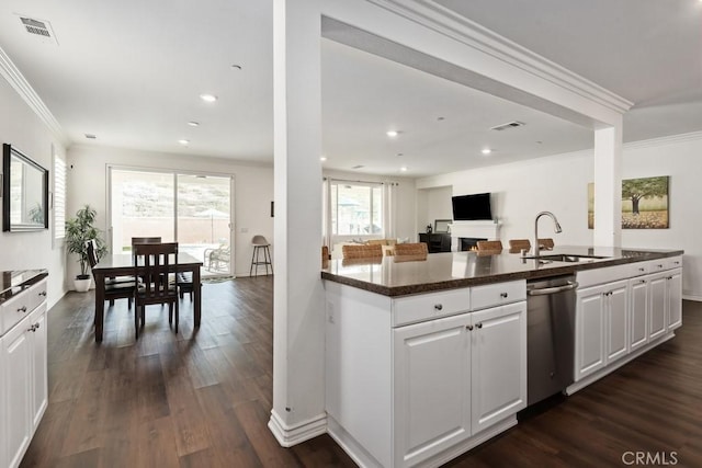 kitchen featuring sink, dark wood-type flooring, dishwasher, and white cabinets