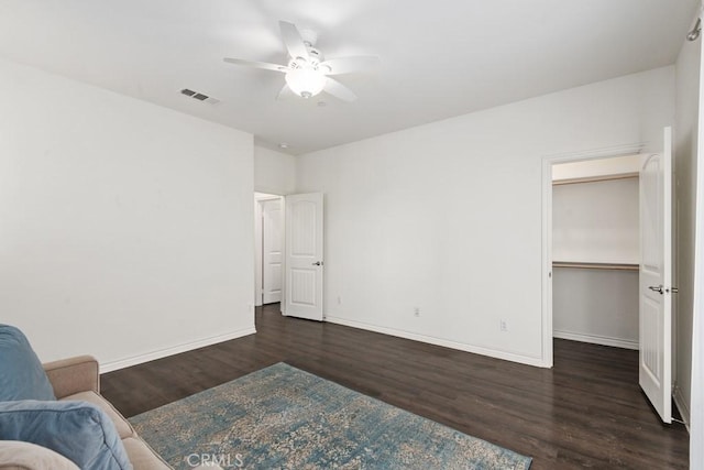 unfurnished bedroom featuring ceiling fan and dark hardwood / wood-style flooring