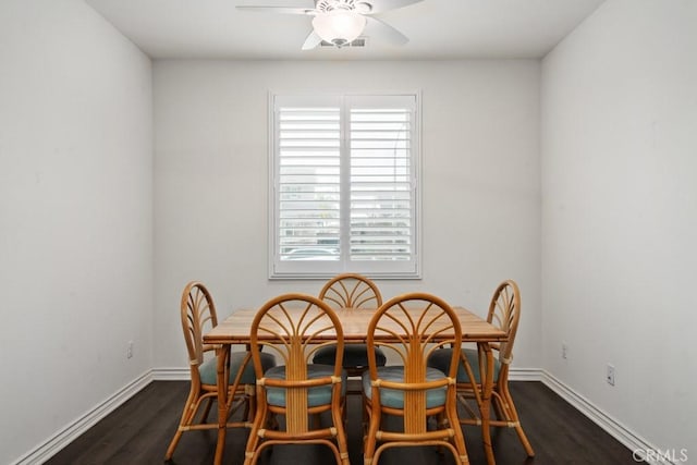 dining space featuring dark wood-type flooring and ceiling fan