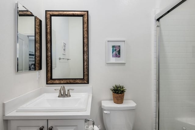 bathroom with vanity, toilet, and a shower with shower door