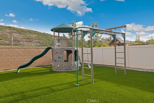 view of jungle gym featuring a lawn