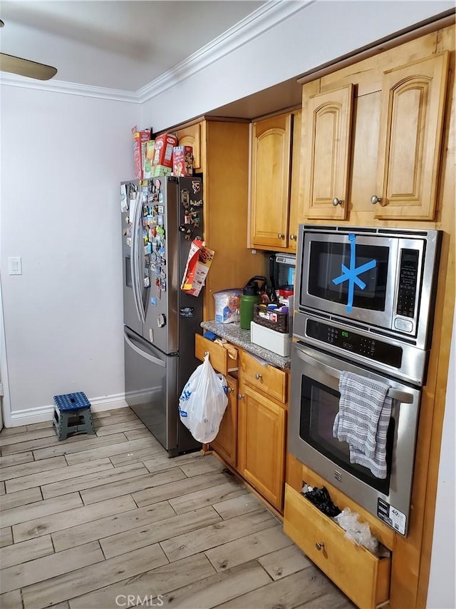 kitchen featuring light wood-type flooring, ornamental molding, and appliances with stainless steel finishes