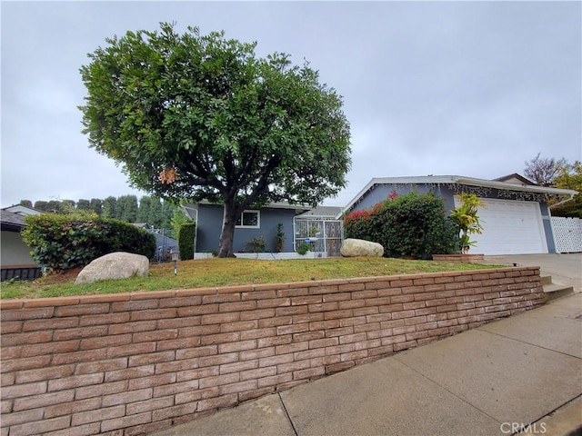 view of front of property featuring a garage and a lanai