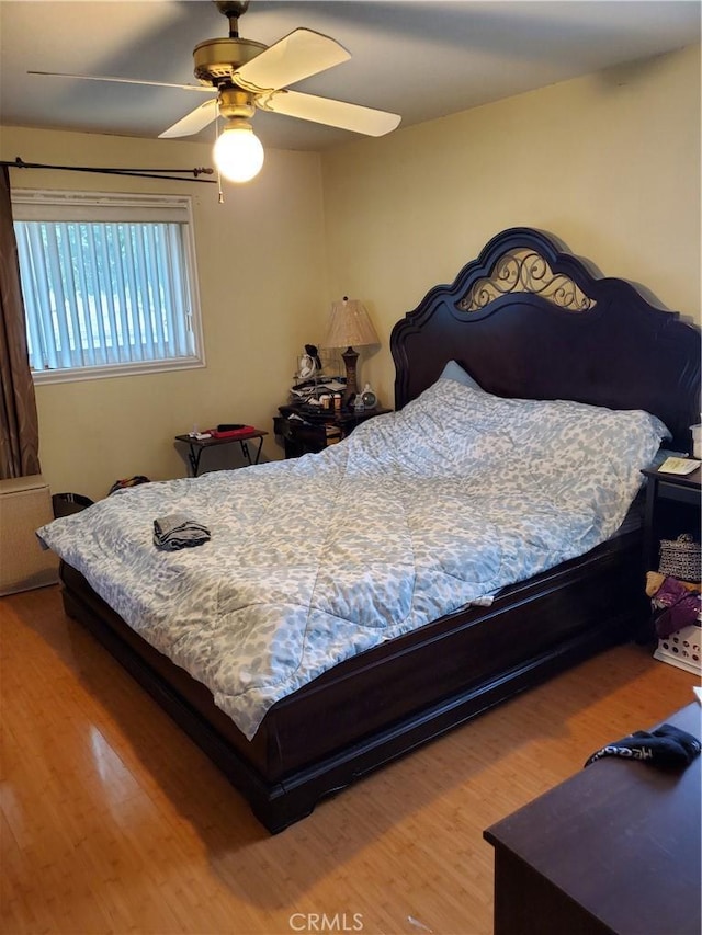 bedroom with wood-type flooring and ceiling fan