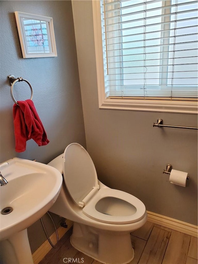 bathroom with sink, hardwood / wood-style floors, and toilet