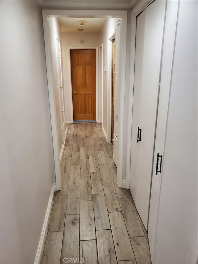 corridor featuring light hardwood / wood-style floors