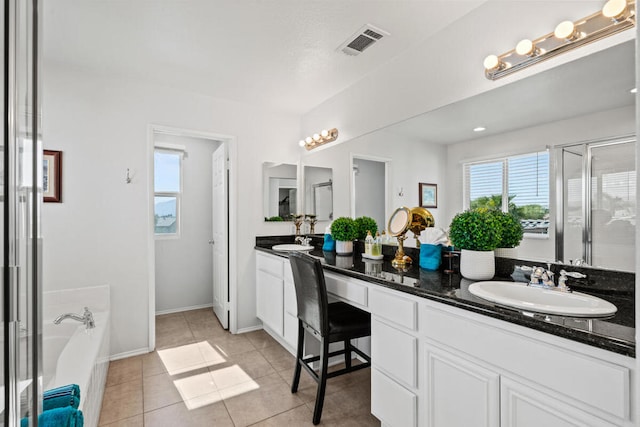 bathroom with tile patterned flooring, vanity, independent shower and bath, and a wealth of natural light