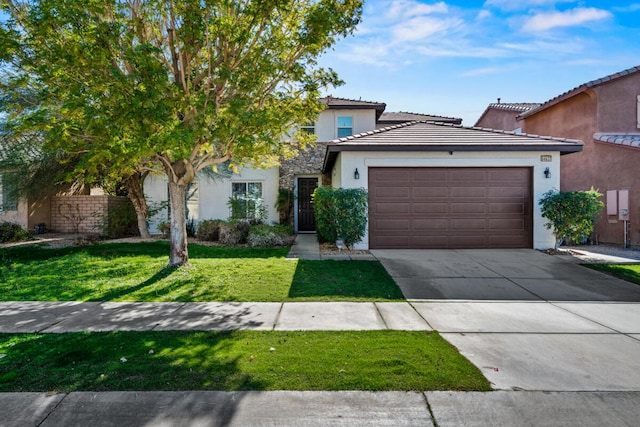 view of front of property with a garage and a front lawn