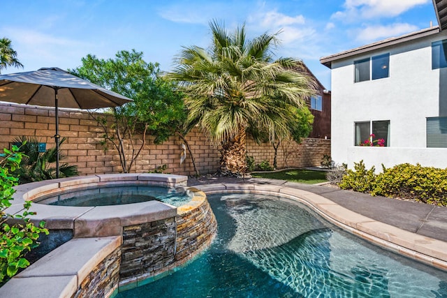 view of swimming pool featuring an in ground hot tub