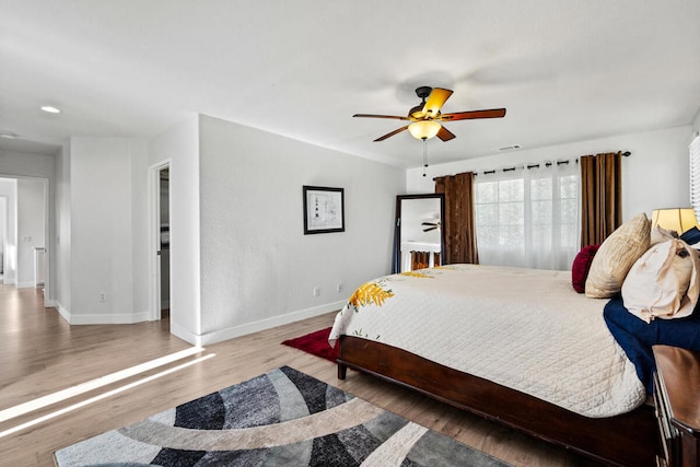 bedroom with wood-type flooring and ceiling fan