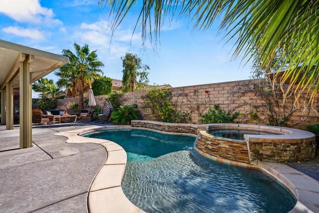 view of swimming pool featuring an in ground hot tub and a patio area