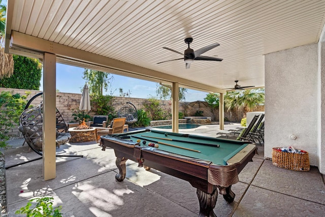 view of patio / terrace featuring ceiling fan, an outdoor fire pit, and a fenced in pool