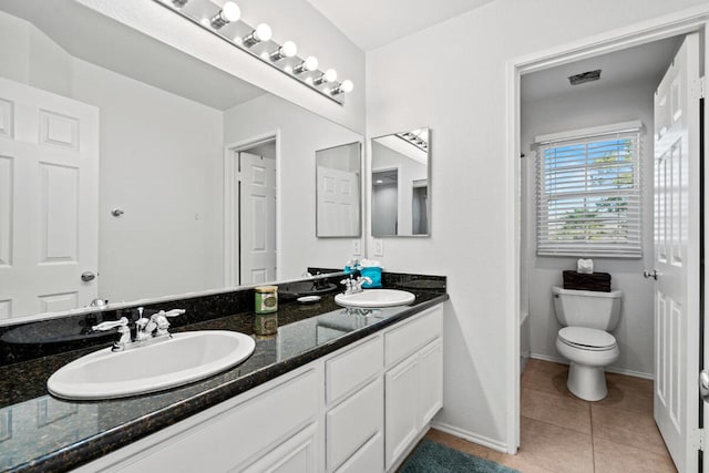 bathroom featuring vanity, tile patterned floors, and toilet