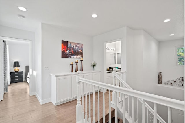 corridor with light hardwood / wood-style floors