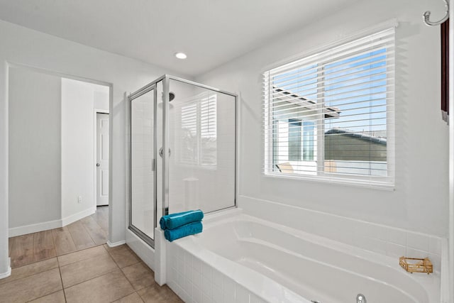 bathroom featuring independent shower and bath and tile patterned flooring