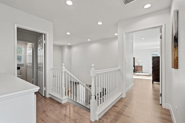 hall featuring plenty of natural light and light wood-type flooring