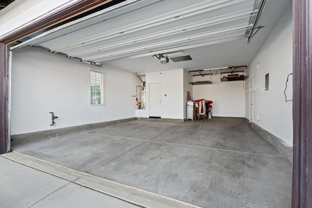 garage with secured water heater and a garage door opener