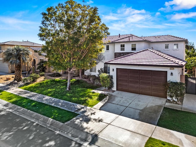 view of front facade featuring a garage and a front yard