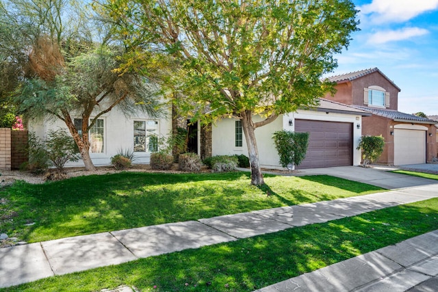 obstructed view of property featuring a garage and a front yard