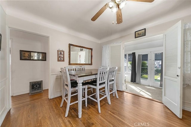 dining space with ceiling fan and light hardwood / wood-style floors