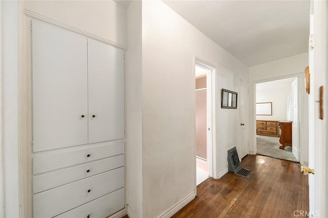 hallway with dark hardwood / wood-style floors