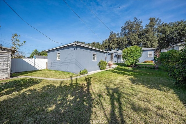 rear view of house with a yard