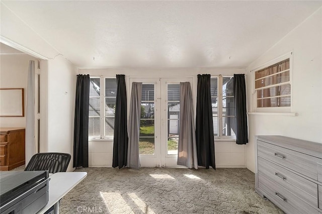 doorway to outside featuring light colored carpet